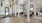 a large room with a wood floor and white pillars