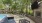 a patio with chairs and a table by a pool