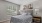 a bedroom with a bed and lamps
