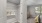 a room with a white door and a white bed with a white railing